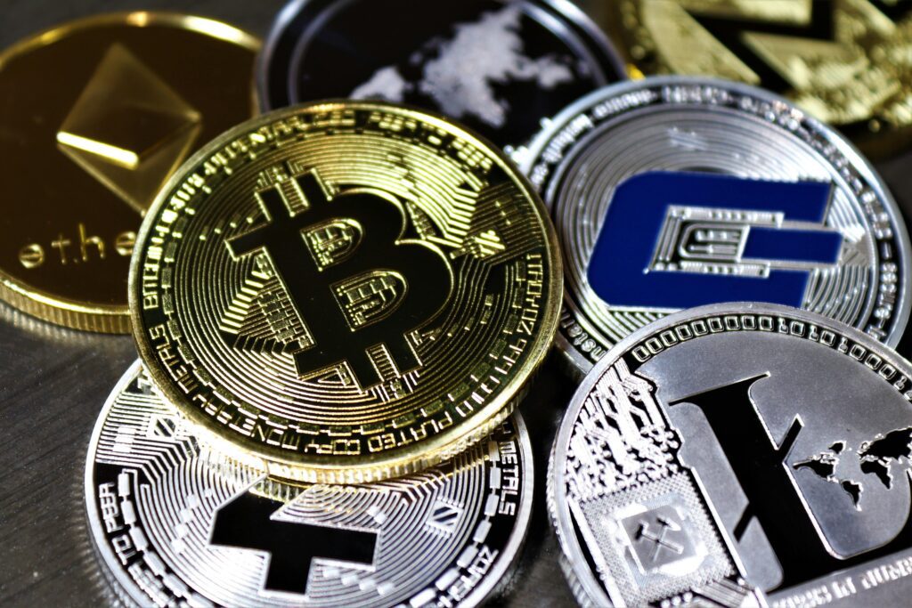 Close-up view of assorted cryptocurrency coins featuring Bitcoin, Litecoin, and others, symbolizing digital finance.