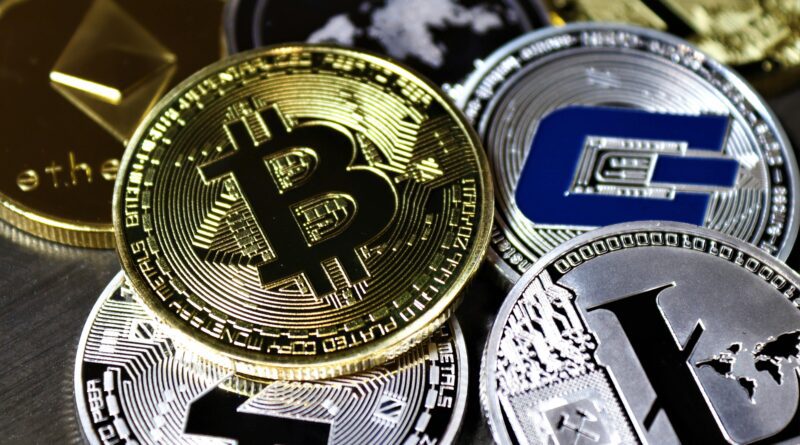 Close-up view of assorted cryptocurrency coins featuring Bitcoin, Litecoin, and others, symbolizing digital finance.